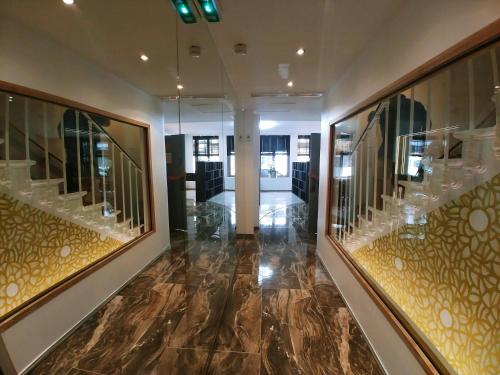 a hallway of a building with glass and marble floors at Hotel Aida Opera in Paris