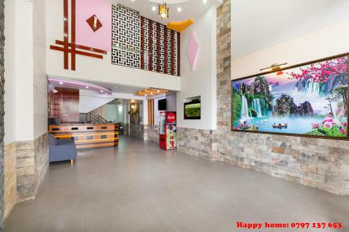 a lobby of a hospital with a painting on the wall at Happy Home in Ho Chi Minh City