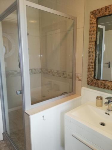 a bathroom with a sink and a mirror at 504 Witsand in Bloubergstrand