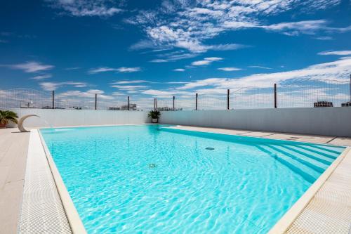 a swimming pool on the roof of a building at Hotel Vienna in Lignano Sabbiadoro