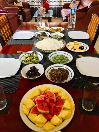 a table with a plate of food on a table at Sweet Home Tourist Rest, Cooking Classes & Tours in Anuradhapura