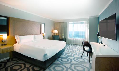 a hotel room with a large bed and a television at Caesars Windsor Hotel and Casino in Windsor