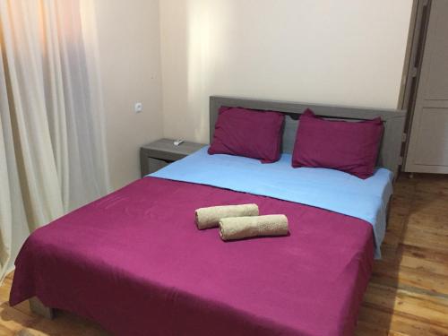 a bedroom with a large bed with two towels on it at Guest House Marani in Sighnaghi
