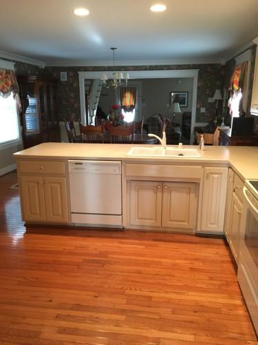 a kitchen with white cabinets and a sink at Downtown abode in the heart of the Bourbon Trail in Lebanon