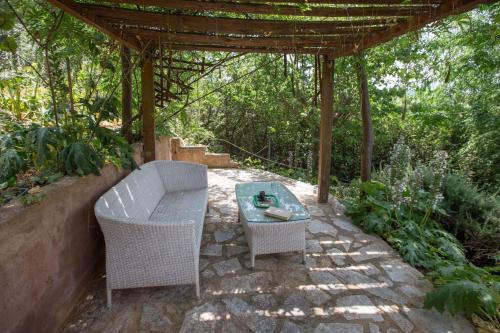 a patio with a table and chairs under a pergola at Family Getaway in Marathon by GHH in Marathón