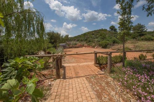 a wooden gate leading to a dirt road at Family Getaway in Marathon by GHH in Marathón