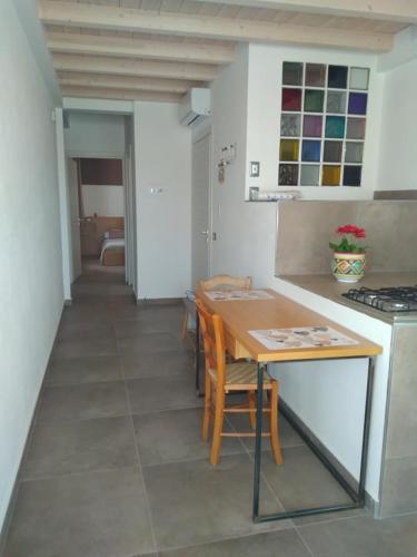a kitchen with a table and chairs in a room at Via Ziino 70 in Oliveri