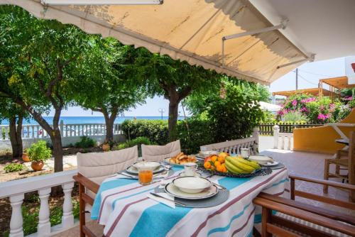 a table with a bowl of fruit on it on a patio at Stegnailion in Archangelos