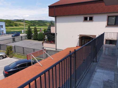 a balcony with a black fence and a car at Apartman Max 2 in Biškupec Zelinski