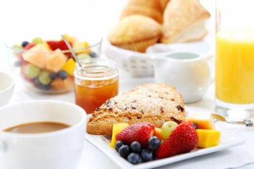 a plate of food with fruit and toast and a cup of coffee at Radisson Hotel Seattle Airport in SeaTac