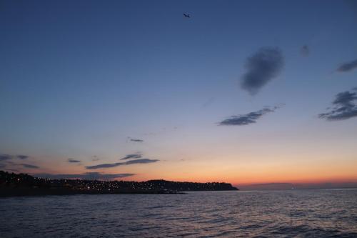 a sunset over the water with a island in the distance at istanbul Airport Kumsal Otel in Arnavutköy