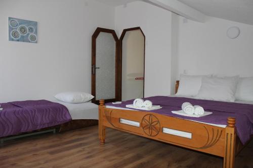 a bedroom with two beds and a table with two mirrors at Petroski Apartments in Ohrid