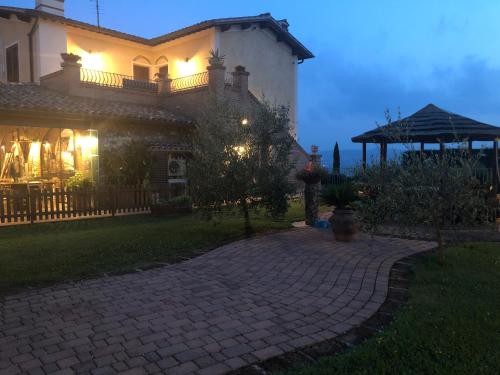 a house with a brick walkway in front of it at Casa in campagna a due passi dal mare in Pisa