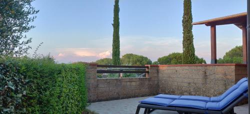 a pair of blue chairs sitting on a brick wall at Locanda Mossa Dei Barbari in Buriano