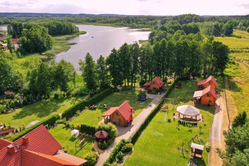 an aerial view of a village with a river at Domki u Jacka in Wilkasy