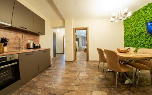 a kitchen and dining room with a table and chairs at Sofia Crown Life Apartment in Sofia