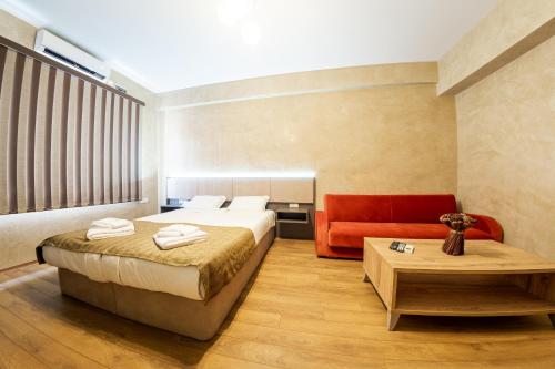 a hotel room with a bed and a couch at Sofia Crown Life Apartment in Sofia