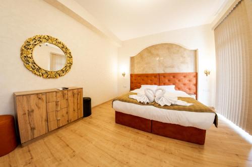 a bedroom with a large bed and a mirror at Sofia Crown Life Apartment in Sofia