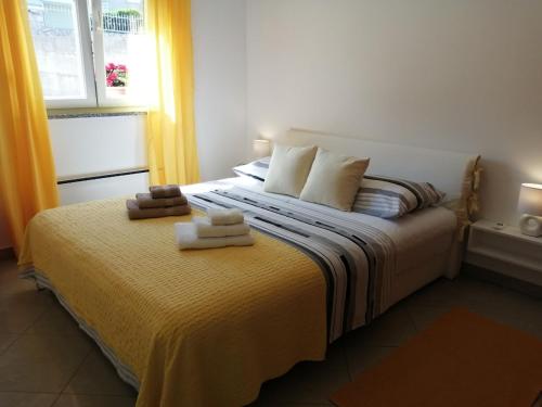 a bedroom with a bed with two towels on it at K&D in Rijeka