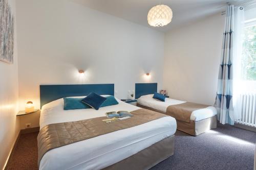 Ένα ή περισσότερα κρεβάτια σε δωμάτιο στο Hotel De La Pommeraie