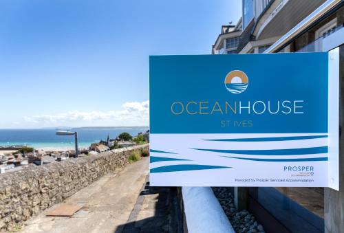 a sign for an ocean house on a building at Ocean House in St Ives