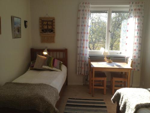 a bedroom with a bed and a desk and a window at Storliens Fjällgård in Storlien