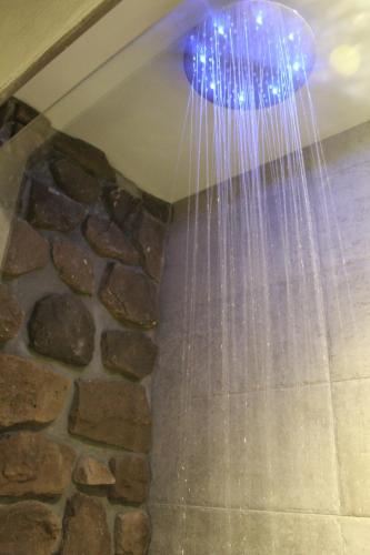 a shower with lights hanging from the ceiling at Villa Martina Luxury Rooms in Desenzano del Garda