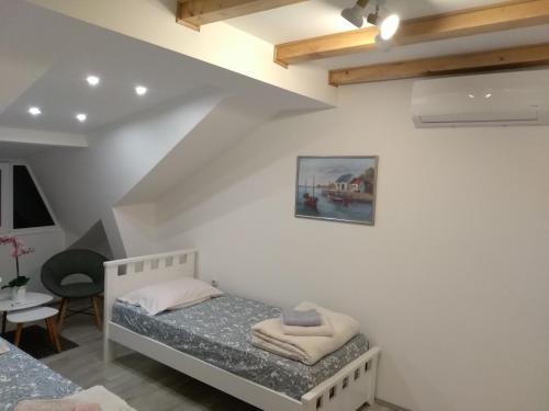 a small room with a bed and a table at Guest House Stankovic in Soko Banja