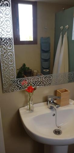 a bathroom with a sink and a mirror at Elescondite in Sauzal