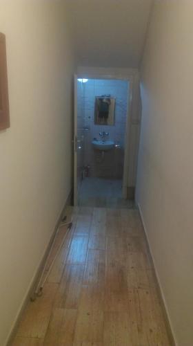 an empty bathroom with a sink and a mirror at Sweet Dream Rooms in Podgorica
