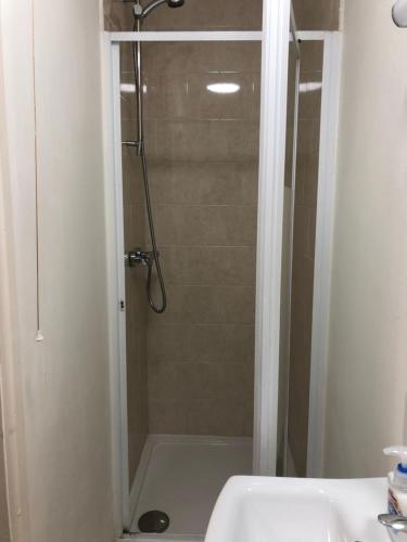 a bathroom with a shower with a glass door at The Bell Hotel in Newtown