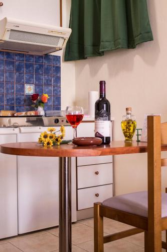 a kitchen with a table with two glasses of wine at Sun & Sea in Mochlos