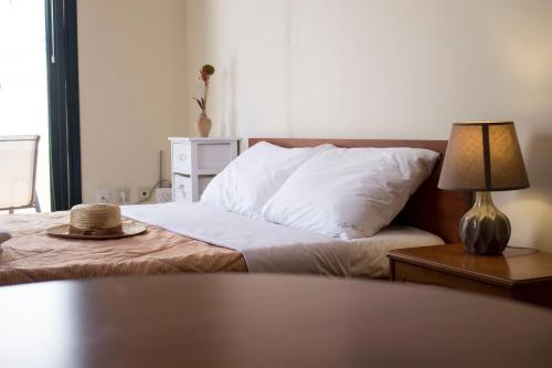 a bedroom with a bed with a hat on it at Sun & Sea in Mochlos