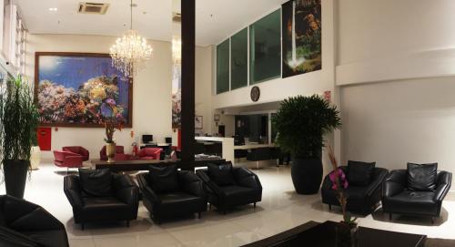 a lobby with couches and chairs in a building at Hotel D'Luca in Cuiabá
