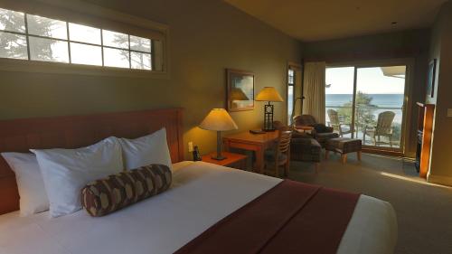 a hotel room with a bed and a living room at Long Beach Lodge Resort in Tofino