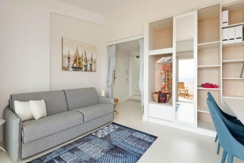 a living room with a couch and a dining room at Akti Elia Villas Beachfront Chalkidiki in Elia