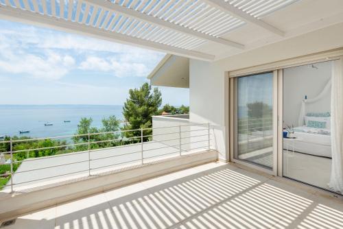 a balcony with a view of the ocean at Akti Elia Villas Beachfront Chalkidiki in Elia