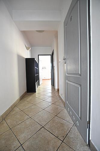 an empty hallway with a door and a tiled floor at Mhost Bronowice in Kraków