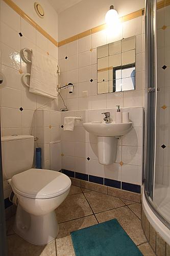 a bathroom with a toilet and a sink at Mhost Bronowice in Kraków