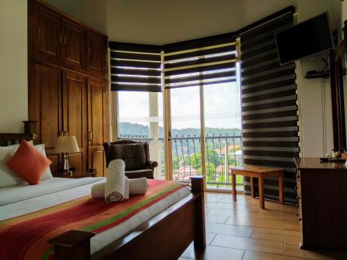 a bedroom with a bed and a large window at 36 Bed & Breakfast in Kandy