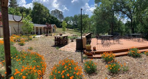 a patio with a table and chairs and flowers at Red Tail Ranch in Groveland