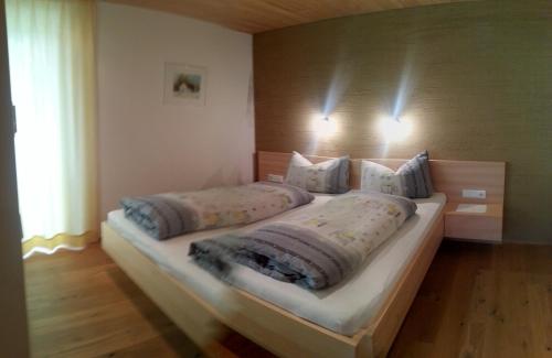 a bedroom with a large bed with two pillows at Ferienwohnungen Abel in Damuls