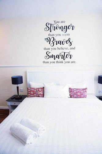 a bedroom with a bed with two towels on it at TY Hotel in Kuala Terengganu