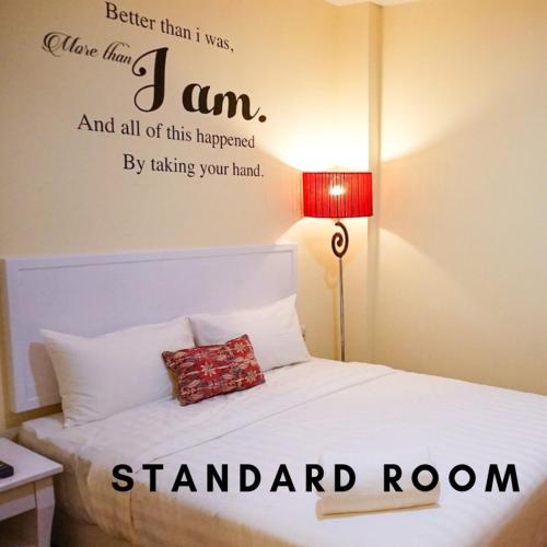 a bedroom with a bed with a sign on it at TY Hotel in Kuala Terengganu