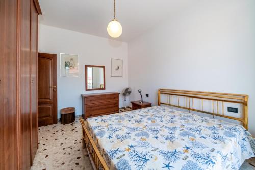 a bedroom with a bed with a blue and white comforter at Bolle blu - By Ligooria in Borgio Verezzi