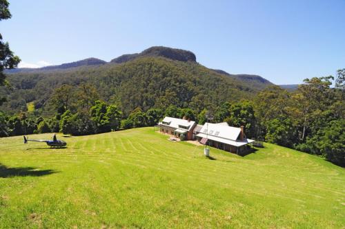 an aerial view of a house on a grassy hill at Yeola Lush location with river access in Upper Kangaroo River