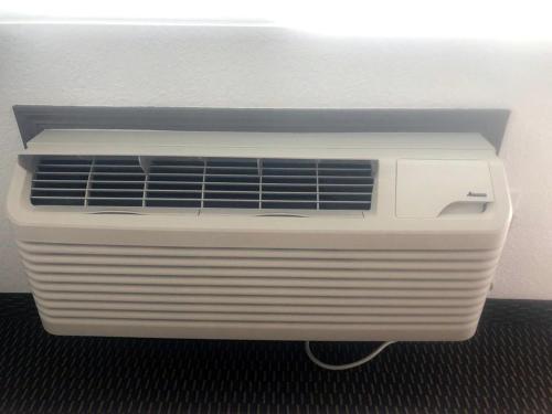 a white air conditioner sitting in a room at Westward Inn in Crescent City