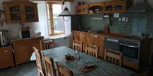 a kitchen with a table and chairs and a kitchen with a tableablish at U dobrého hospodára in Bešeňová