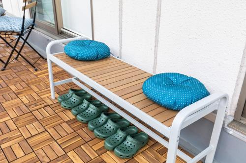 a table with pillows sitting on top of a porch at RIVER VILLAS HIROSHIMA in Hiroshima