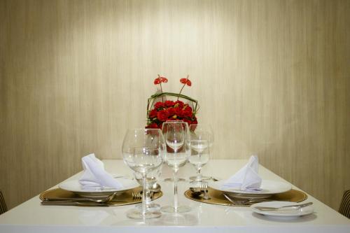 a table with wine glasses and napkins on it at Golden Prince Hotel & Suites in Cebu City